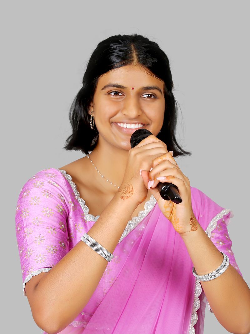 Mallika Suryadevara singing, holding a microphone